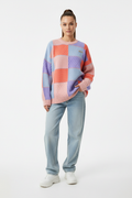 Female model in colorful patchwork pullover sweater